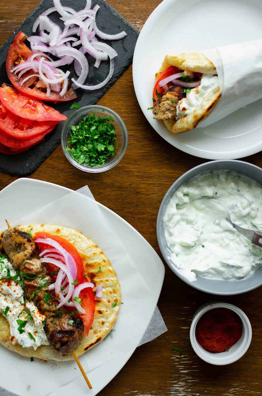 Picture of Souvlaki and sauces on dishes and plates